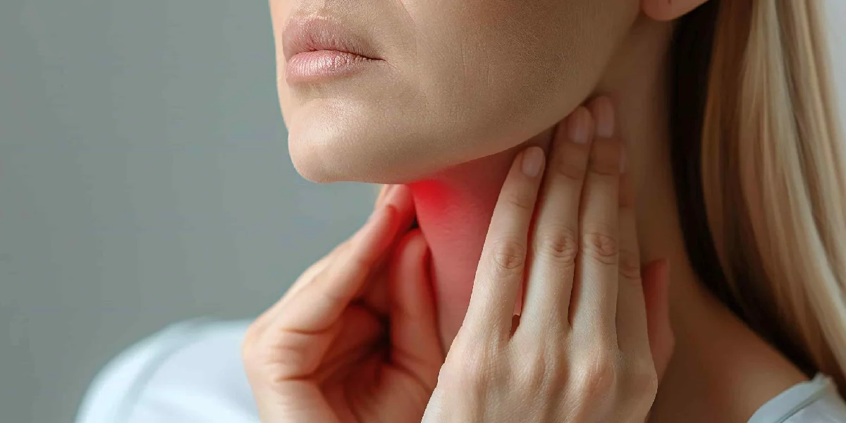 A person holds their hands to their throat and neck, highlighted with a red glow to indicate pain or a sore throat, representing Throat Conditions in North Logan, UT.
