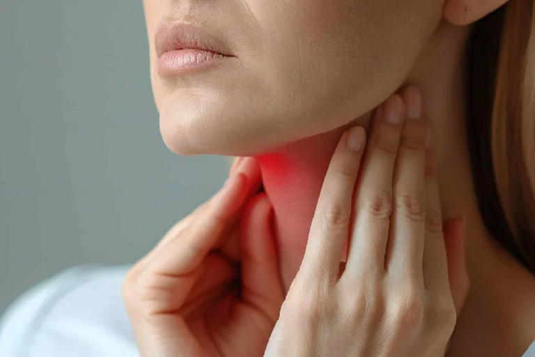 A person holds their hands to their throat and neck, highlighted with a red glow to indicate pain or a sore throat, representing Throat Conditions in North Logan, UT.